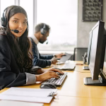 a smiling woman working in a call center while looking at camera